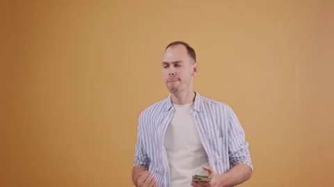 Young man emotionally interacts with smartphone and wins or reaches his goals Stock Footage 289099208