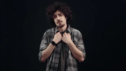 Young man, emotionally surprised, makes his heart gesture with his hand and Vídeo Stock 150311237