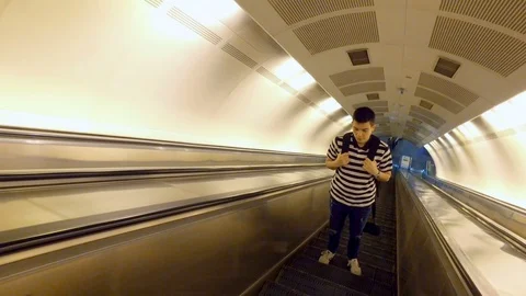 Young man on empty escalator going up from a subway Stock Footage 91656716