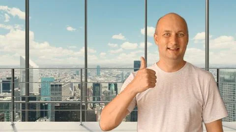 A young man in an empty office draws an evaluation of the service on a virtual Stock Photos