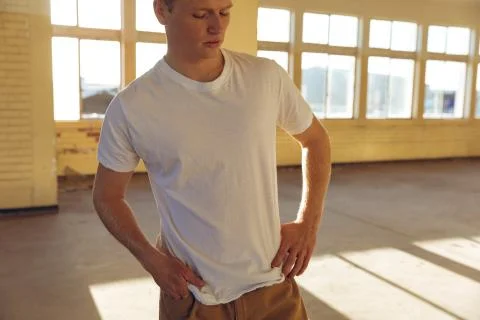 Young man in empty warehouse 스톡 사진