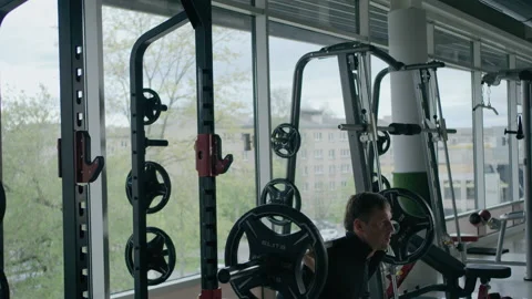 Young man is engaged in crossfit, doing leg exercises, warming up, in the gym. Stock Footage 130414058