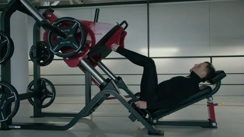 Young man is engaged in crossfit, doing leg exercises, warming up, in the gym. Stock Footage 130418582