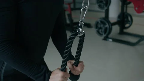 Young man is engaged in crossfit, doing triceps exercise, warming up, in the gym Stock Footage 130421443