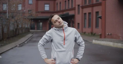 A young man is engaged in warm-up before running. Close-up portrait of a man Stock Footage 120771056