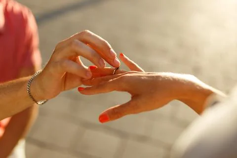 Young man with engagement ring making proposal to his beloved girlfriend Stock Photos