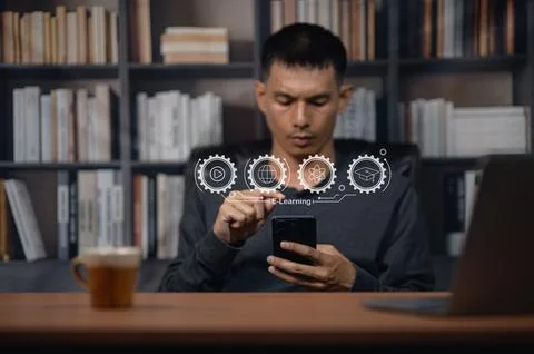 Young man engaging with digital interface and futuristic icons in library s.. Photos