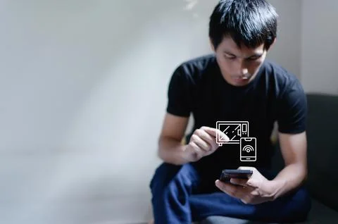 Young Man Engaging with Smart Technology and Modern Devices Stock Photos