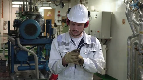 Young man engineer in white work wear clothes a safety gloves Stock Footage 117348195