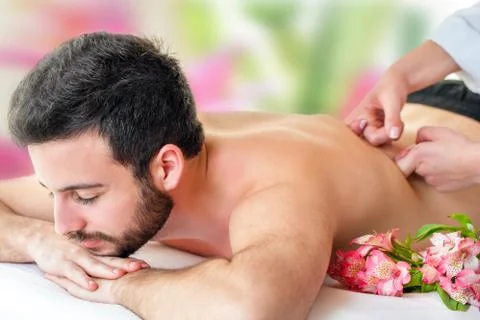Young man enjoying back massage. Stock Photos