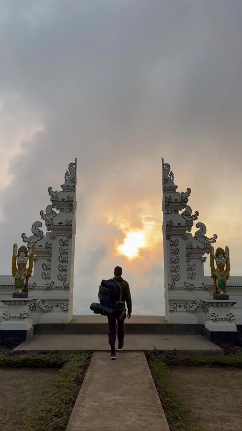 Young man enjoying a bright day in the nature, man walking to volcano Agung in B Stock Footage 301916520