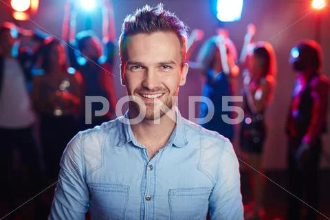 Young man enjoying party in night club Stock Photos