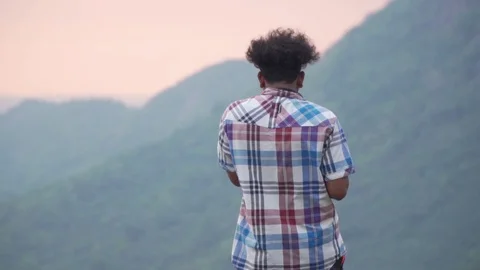 Young man enjoying time on hill top in sunset freedom travel indian sunrise Stock Footage 108894069