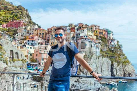 Young man enjoying the view of Manarola in the UNESCO World Heritage Site Cinque Stock Photos