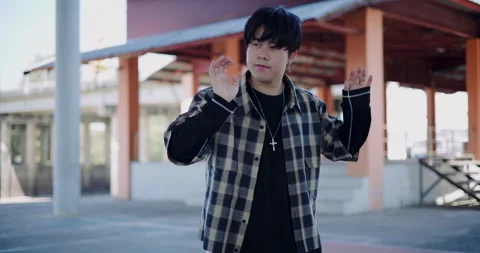 A young man enjoys dancing alone on a holiday in an outdoor dome. Stock-Footage 313177607
