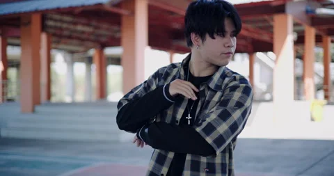 A young man enjoys dancing alone on a holiday in an outdoor dome. 스톡 동영상 313177981