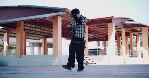 A young man enjoys dancing alone on a holiday in an outdoor dome. Stock-Footage 313178717