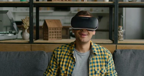 Young man enjoys wearing virtual reality headset Stock Footage 113622945