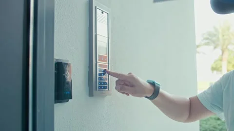 Young man entering authorization code pin on home alarm keypad. Stock Footage 255630534