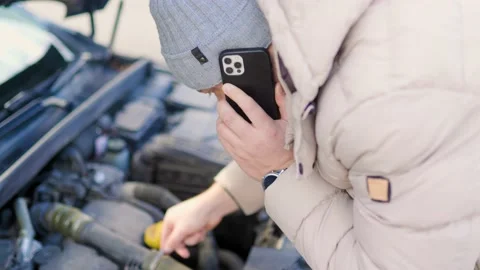 A young man examines the damage engine car Stock Footage 234137073