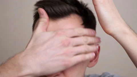 Young man examines his bald spots in the mirror Stock Footage 147190810