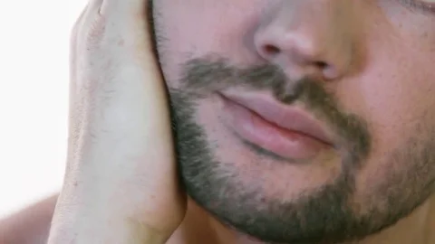 A young man examines his stubble before shaving Stock Footage