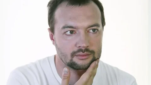A young man examines his stubble before shaving Stock Footage 78140189