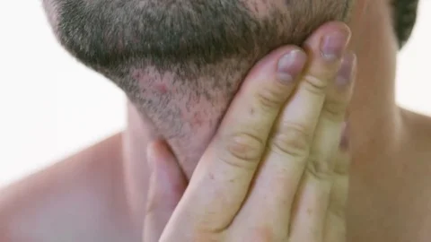 A young man examines his stubble before shaving Stock Footage 78140213