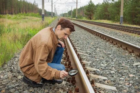 Young man examines the rail surface Stock Photos