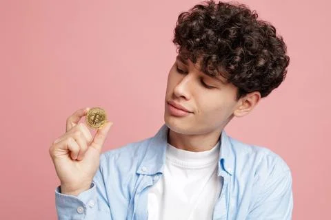 Young man examining crypto coin digital currency investment and blockchain .. Stock Photos