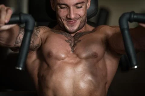 Young Man Exercise Chest On Machine Stock Photos
