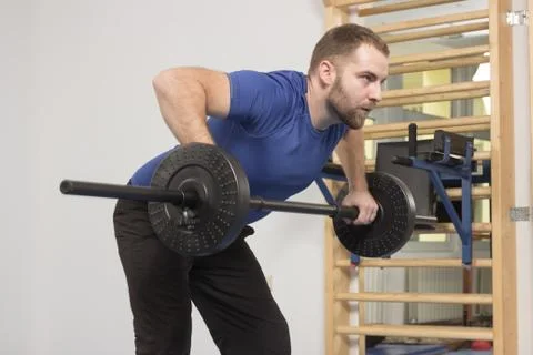 Young man exercise weights, weight bar Stock Photos