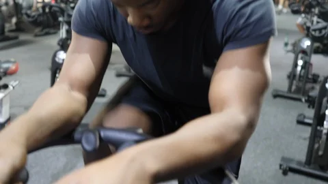 Young Man Exercises With Spinning Exercise Bike at Gym 4K Stock Footage 98671301