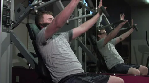 Young man exercising his upper body. Using a machine. Stock Footage 49863011