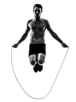 Young man exercising jumping rope silhouette Stock Photos