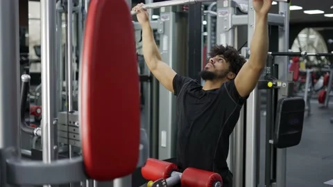 Young man exercising on lateral pull at gym - concept of bodybuilding, healthy 스톡 동영상 196237562