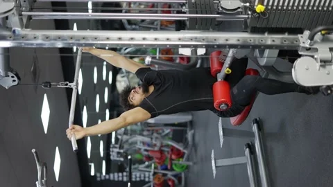 Young man exercising on lateral pull at gym - concept of bodybuilding 스톡 동영상 196706286