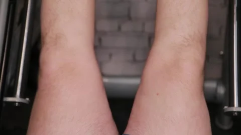 Young man exercising legs on machine in gym Vídeos de archivo 337766444