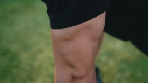 Young man exercising outdoors, does push-ups on the push-up platform at stadium Video stock 260829591