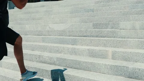 Young man exercising outside. Video camera in slow motion moves together with Stock Footage 136407326