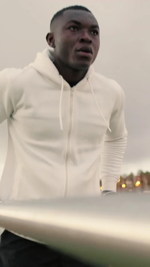 Young man exercising on parallel bars outdoors Stock Footage 284575712