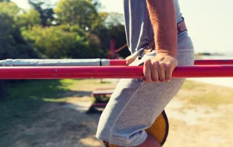 Young man exercising on parallel bars outdoors Stock-Fotos