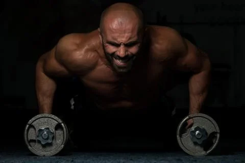 Young Man Exercising Push Ups With Dumbbells Stock Photos