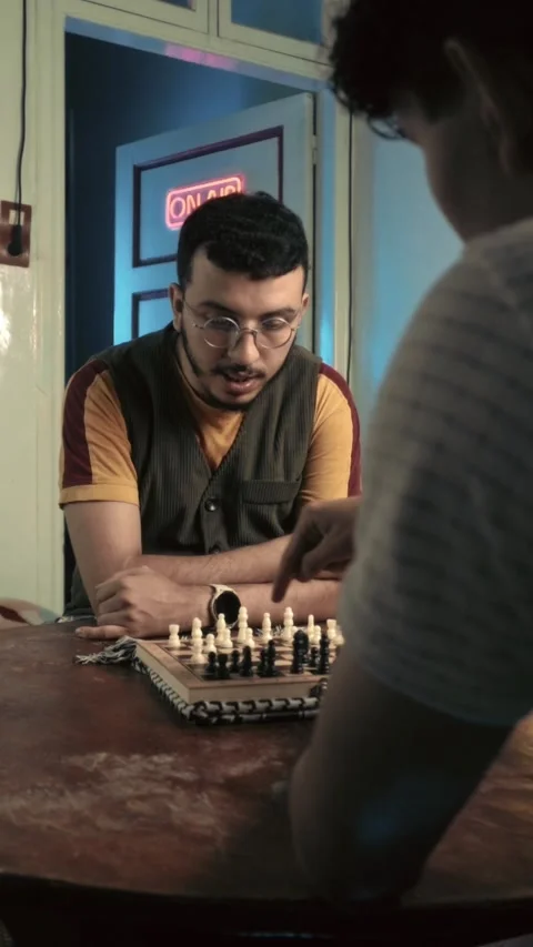 Young Man Explaining Chess Strategy in Neon Studio Stock Footage 321680084