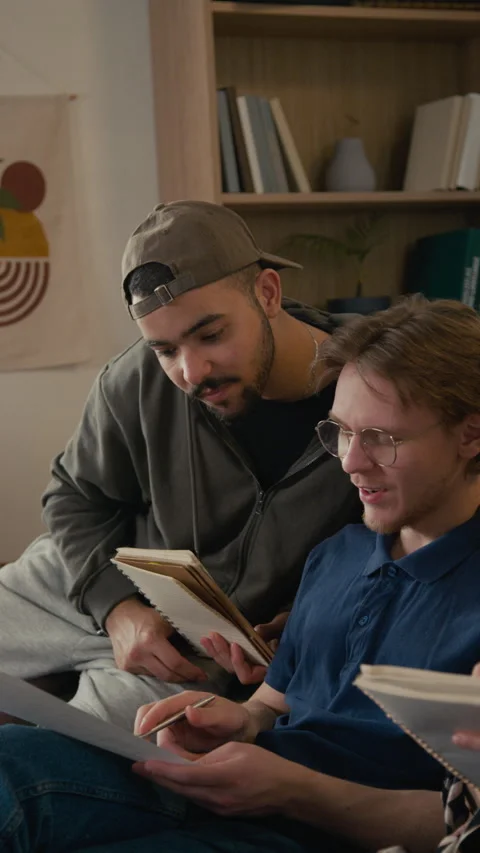 Young Man Explaining Math Problem to Flatmates while Doing College Homework Stock-Footage 336623355