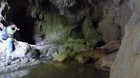 Young man exploring and trekking in a karst cave Stock Footage 37771599