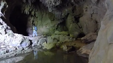 Young man exploring and trekking in a karst cave Stock Footage 37772250