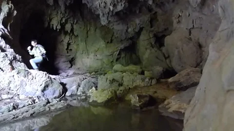 Young man exploring and trekking in a karst cave Stock Footage 37772356