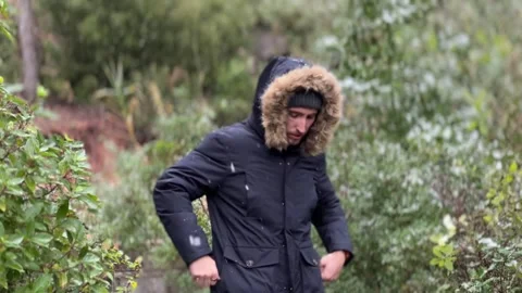 Young man exposed to cold weather in snowy forest environment Stock Footage 326236391