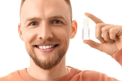 Young man with eye drops on white background, closeup Stock Photos